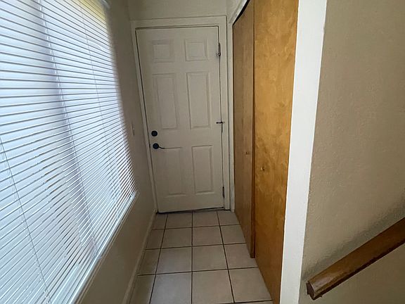 Hallway leading to garage access and washer/dryer area