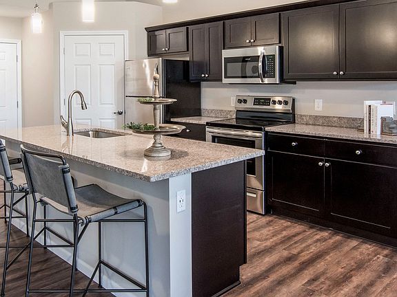 Enjoy a Spacious Kitchen, Complete with Granite Counters and a Generous Island