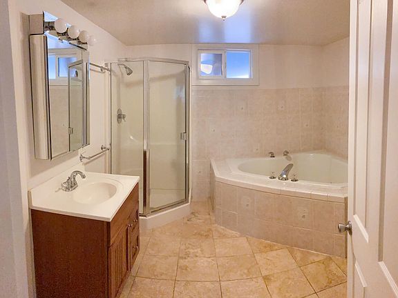 Large bathroom with standup shower and jacuzzi tub for two.