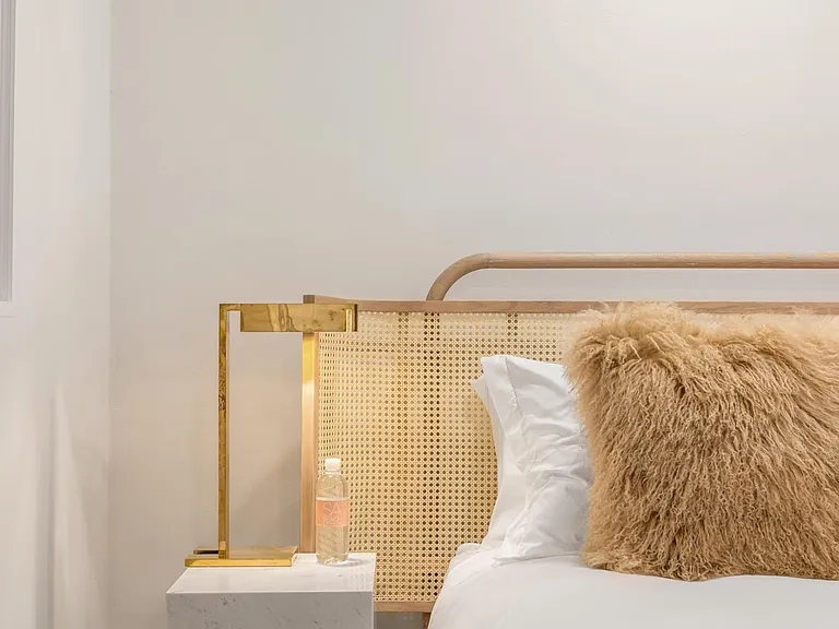 Enjoy elegant slumber in this bedroom with soft, high-quality linen, ensuring a night of pure comfort.