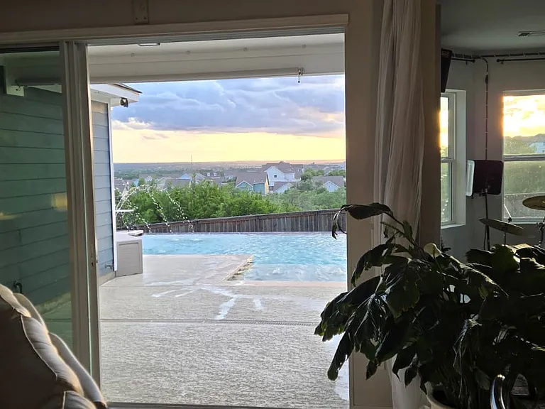The living room opens directly to the pool and that view.