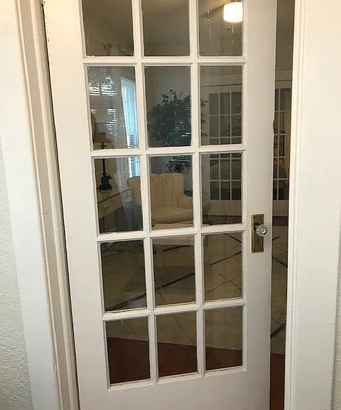 Crystal door knobs, small paned glass door entering the living room from the Florida Room