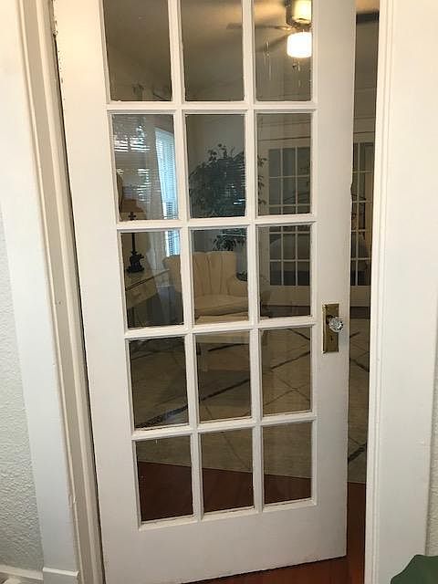 Crystal door knobs, small paned glass door entering the living room from the Florida Room