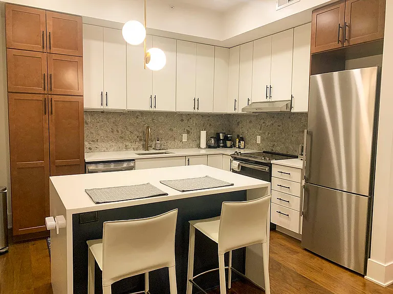 Kitchen with quartz countertop and stainless steel appliances
