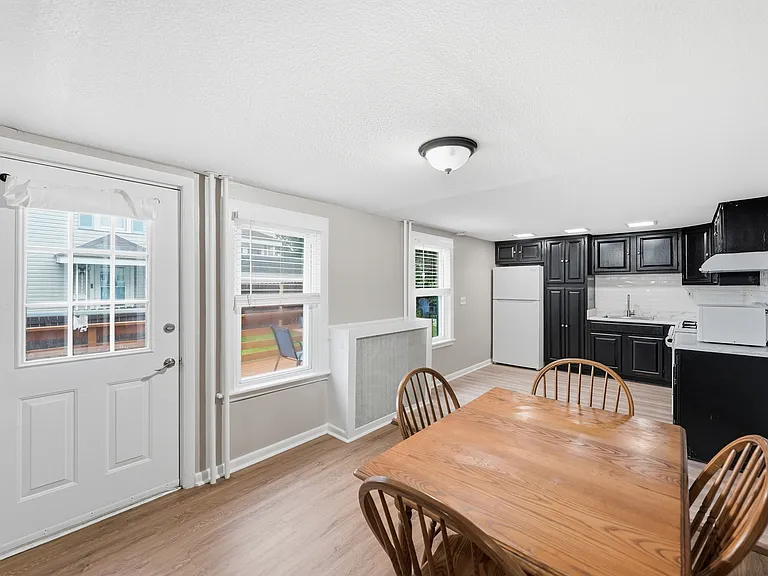 Dining and Kitchen Areas with Direct Access to Deck and Side Yard