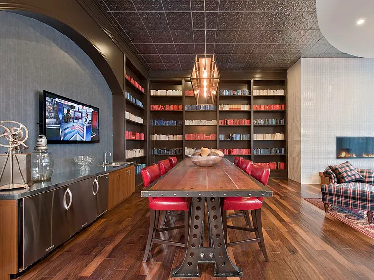 Resident lounge with flat screen television, fireplace, entertaining kitchen and seating