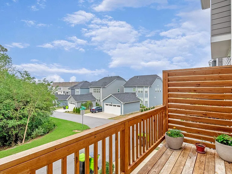 Back balcony overlooking wooded corner lot