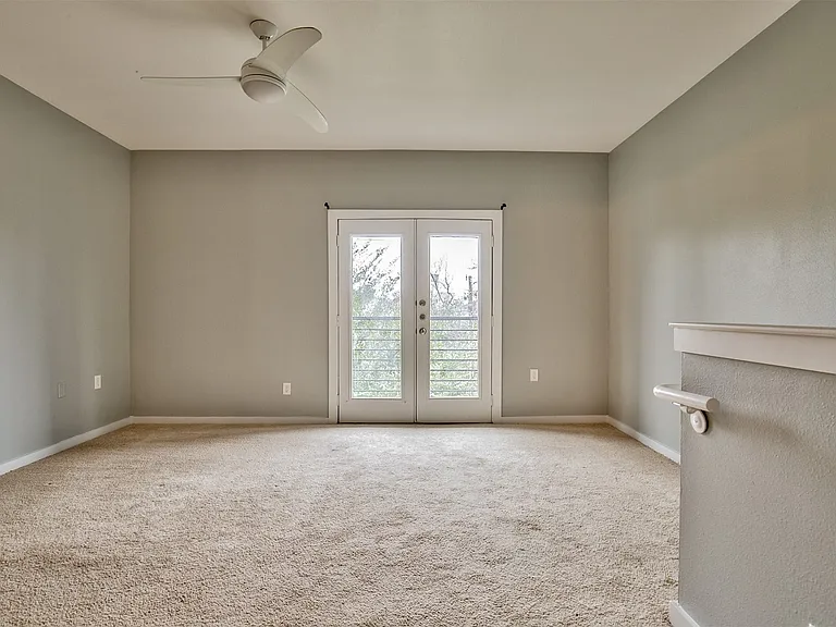 Spacious room featuring neutral carpeting and light gray walls