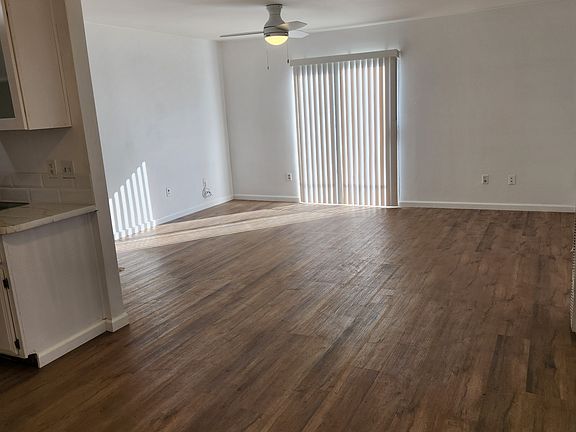 Viewing the living room from the dining room area point of view. Looking towards the bathroom.