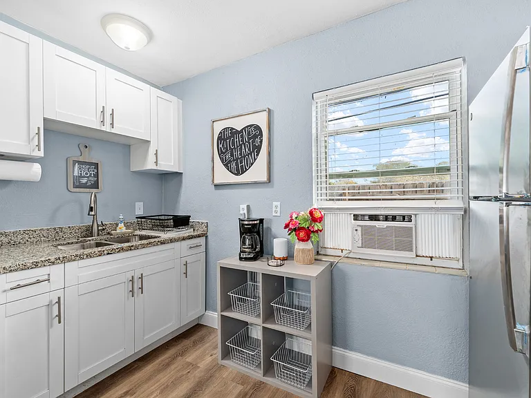 Double Kitchen Sink, Granite Countertops, and White Cabinets