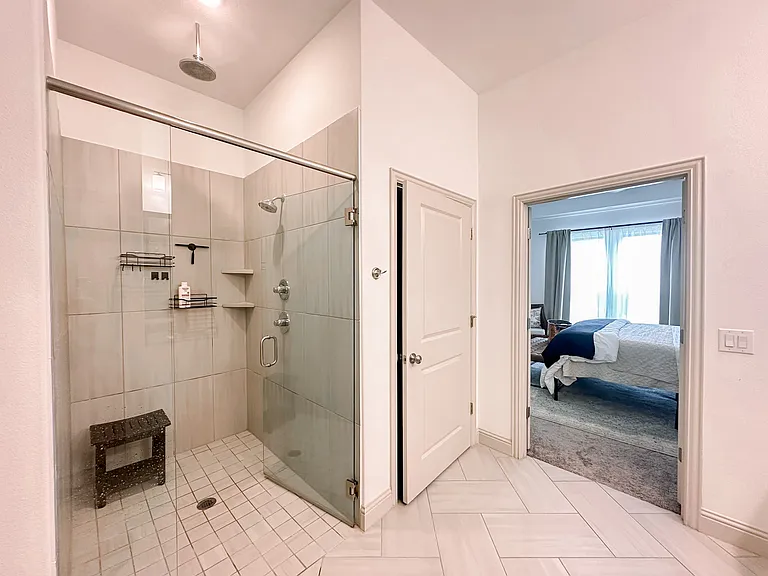 Spa worth bathroom with double vanity, ADA accessible shower with rainhead