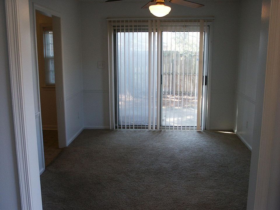 Dining room. Also shows the fenced in back yard