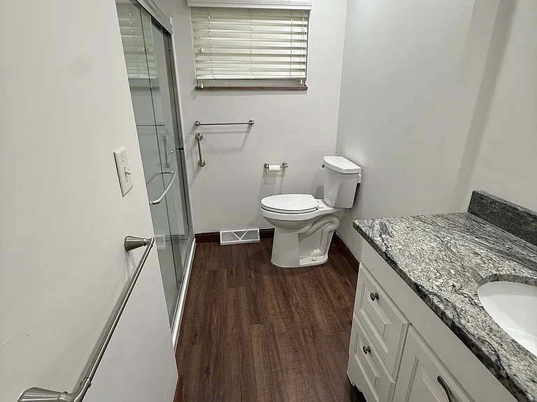 Second full bathroom with granite countertop and shower