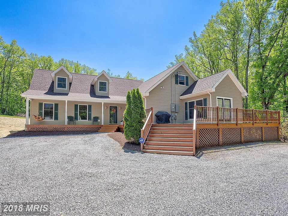 Appealing front entry w/porch and wrap around deck