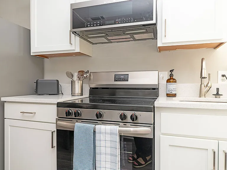 Kitchen with quartz counters, modern cabinetry, & stainless appliances