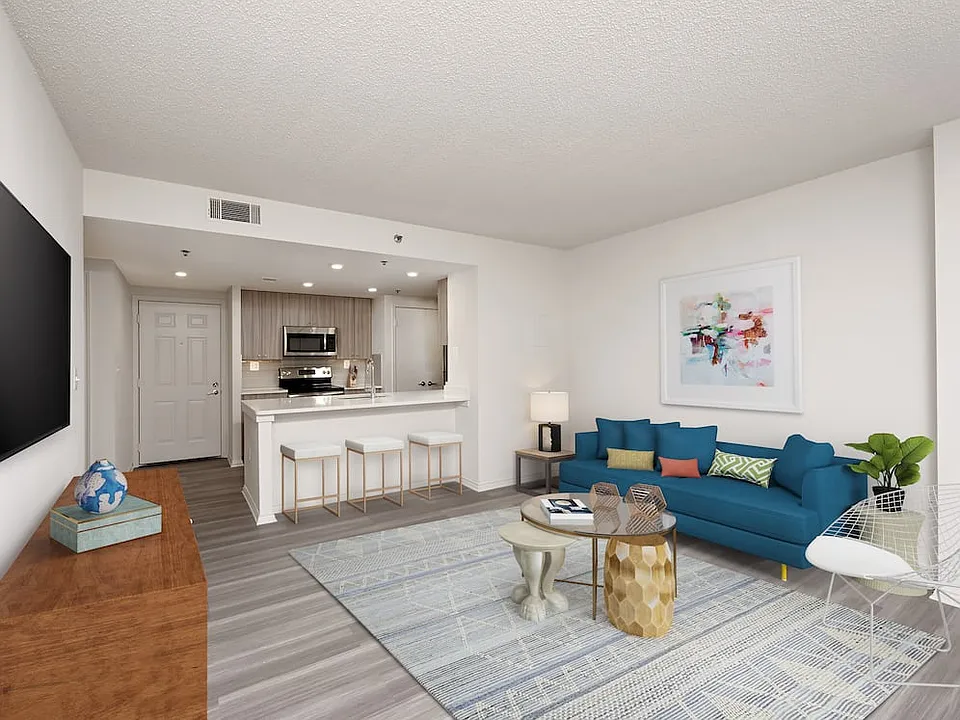 Renovated Package II kitchen, living, and dining areas with hard surface flooring
