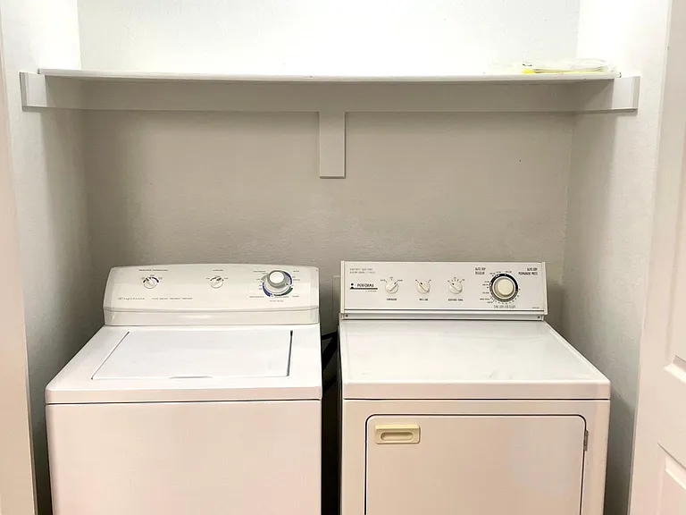 Laundry room with washer and dryer included. Access in the kitchen.