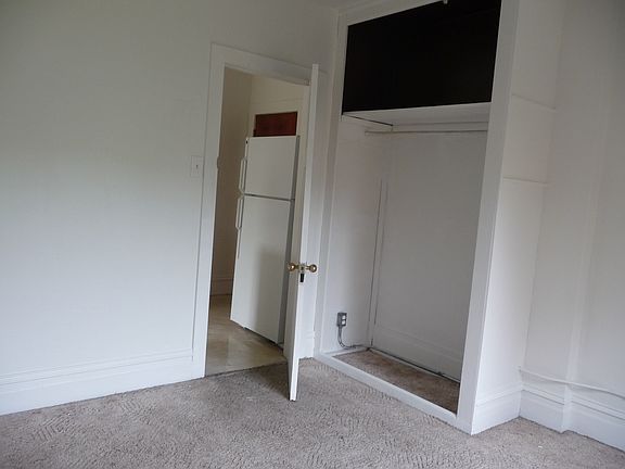 Bedroom (view of closet and entry door into kitchen)