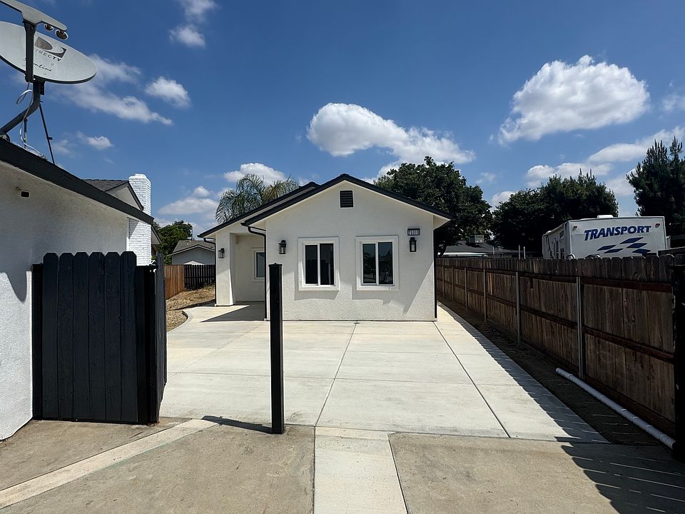 Front entrance of house with gated and secure fence surrounding the premises.