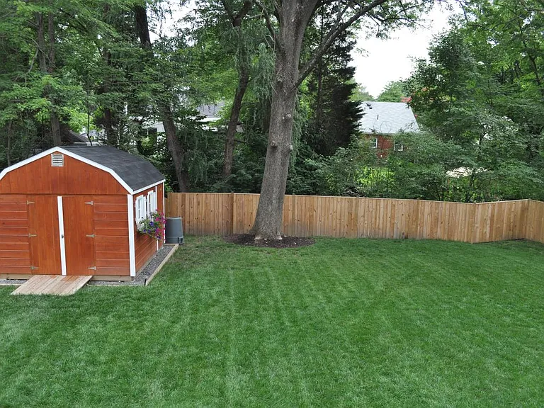 Fully fenced back yard with 10x12 storage shed
