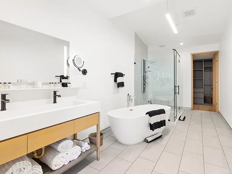 Conveniently designed, rain shower, separate soaking tub and LED lit vanity mirrors.