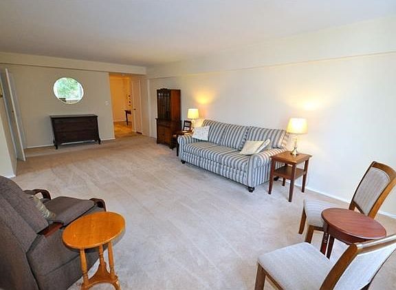 Large living room with golf course views and "L" shaped dining room. The living room has covered har