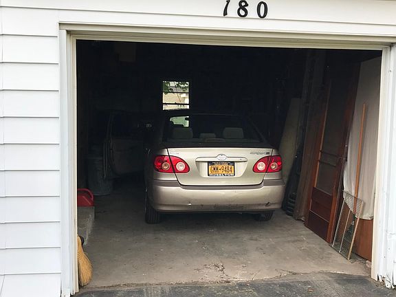 Showing Mid-Size Sedan (Corolla) parked in garage with room 
