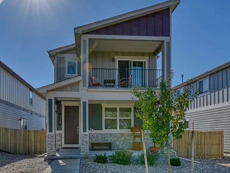Front door, with front patio that has view of Pike's Peak and access to miles of Sand Creek Trail.