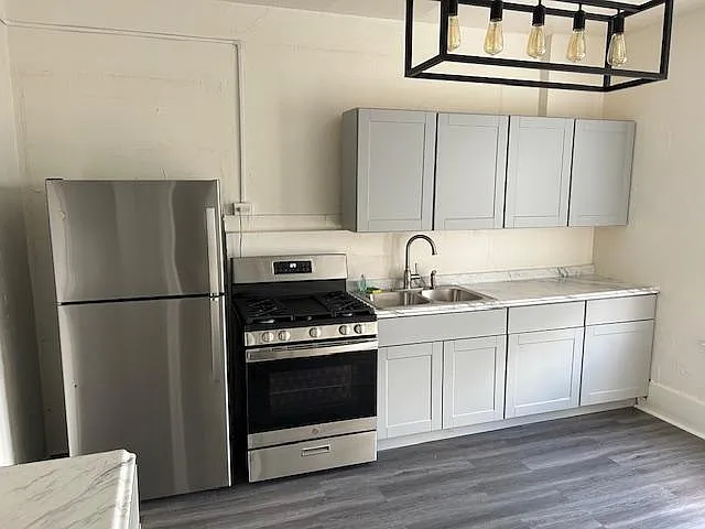 Full kitchen with brand new appliances, cabinets, countertop, sink, faucet and light fixtures.