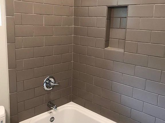 Beautifully tiled shower with niche