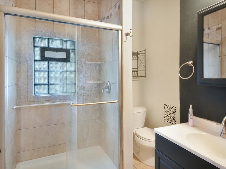 Recently renovated bathroom featuring a walk-in shower.