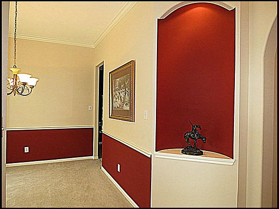 Formal dining with lighted art niche.