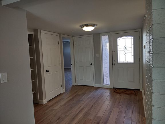 Entry hall with 3 closets. This gorgeous wood-look plank tile throughout the home. No carpet anywhere,