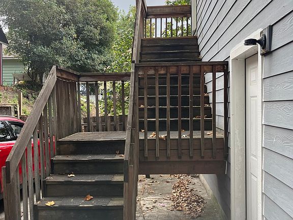 Outside entrance to apartment. Where the red car is the parking for the apartment.