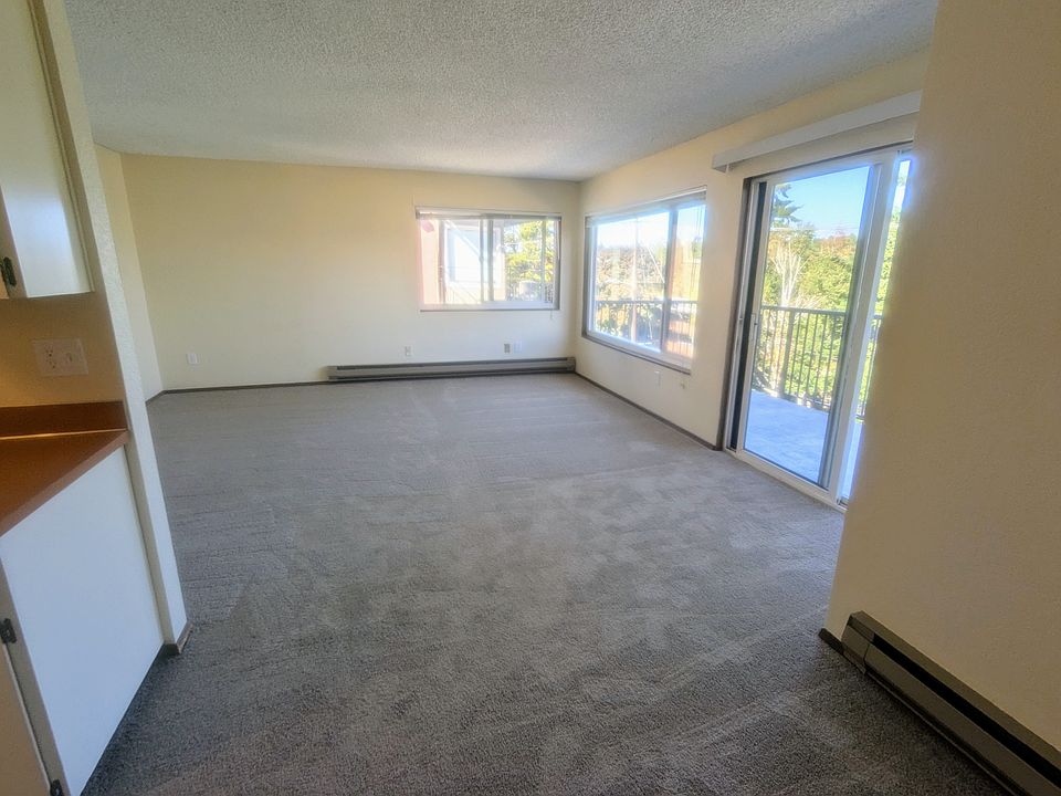 Living room with huge windows, balcony, and northwest views