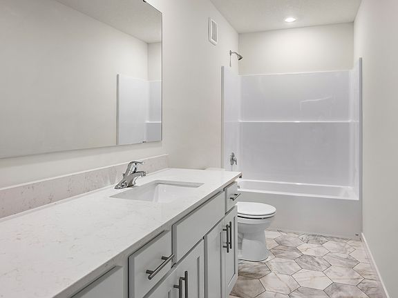 The secondary bedroom also has a tub shower combo