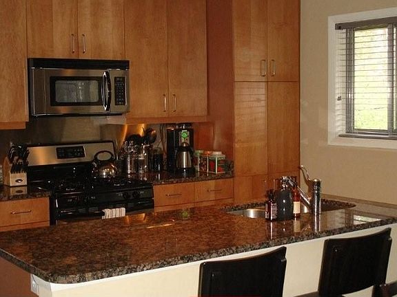 Gourmet Kitchen w/ granite counters, maple cabinets and stainless appliances
