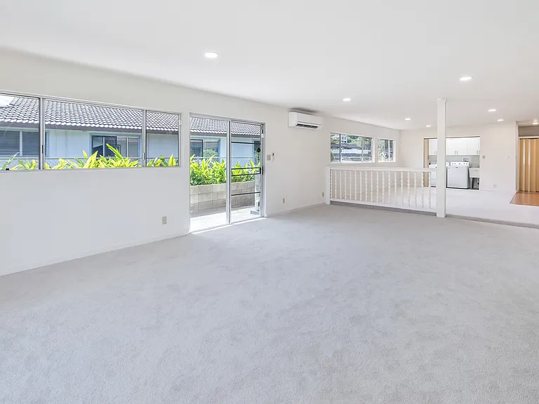 Another view of the family room to show how large it is. Lots of windows and sliding door to side yard. Laundry room in upper center in photo.