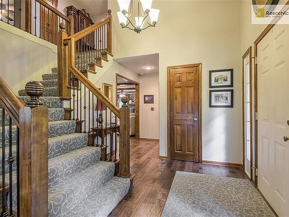 Entry welcomes you with new hardwoods, stair carpet, wood end caps and iron spindles.