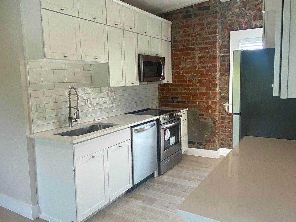 Kitchen has double sided cabinetry on both sides