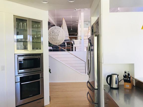 Kitchen and stairway leading to the formal living, dining area, media room and 3rd bedroom