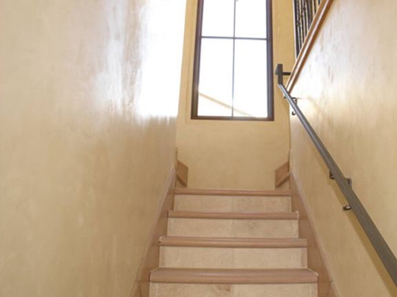 stairs to primary suite and tv room/living room/backyard access