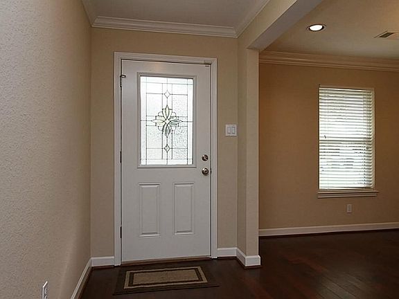 Inviting Entry Features Gleaming Hardwood Floors, Fresh Designer Paint, and convenient Coat Closet. Opens to Spacious Dining Room and Kitchen