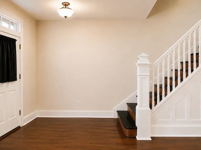 Foyer Entryway featuring Rich Medium-Brown Walnut Flooring with Warm Brown and Bold Black Undertones