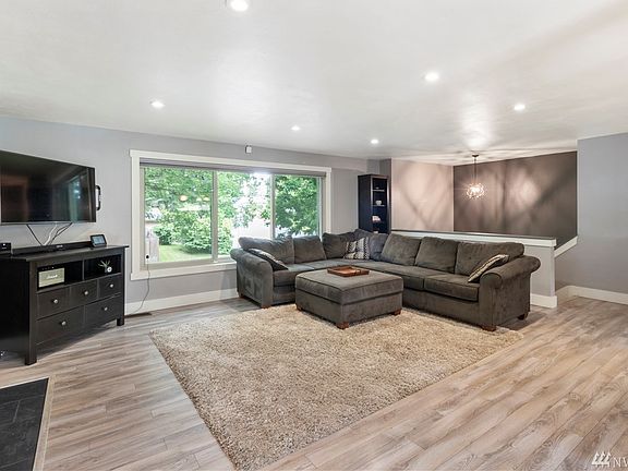This living area offers tons of natural light and beautiful flooring throughout. 