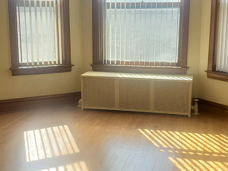 Living-room: Lots of light! Covered radiator, high ceilings, new vertical blinds. Office/possible bdrm, at right (not seen in pics).