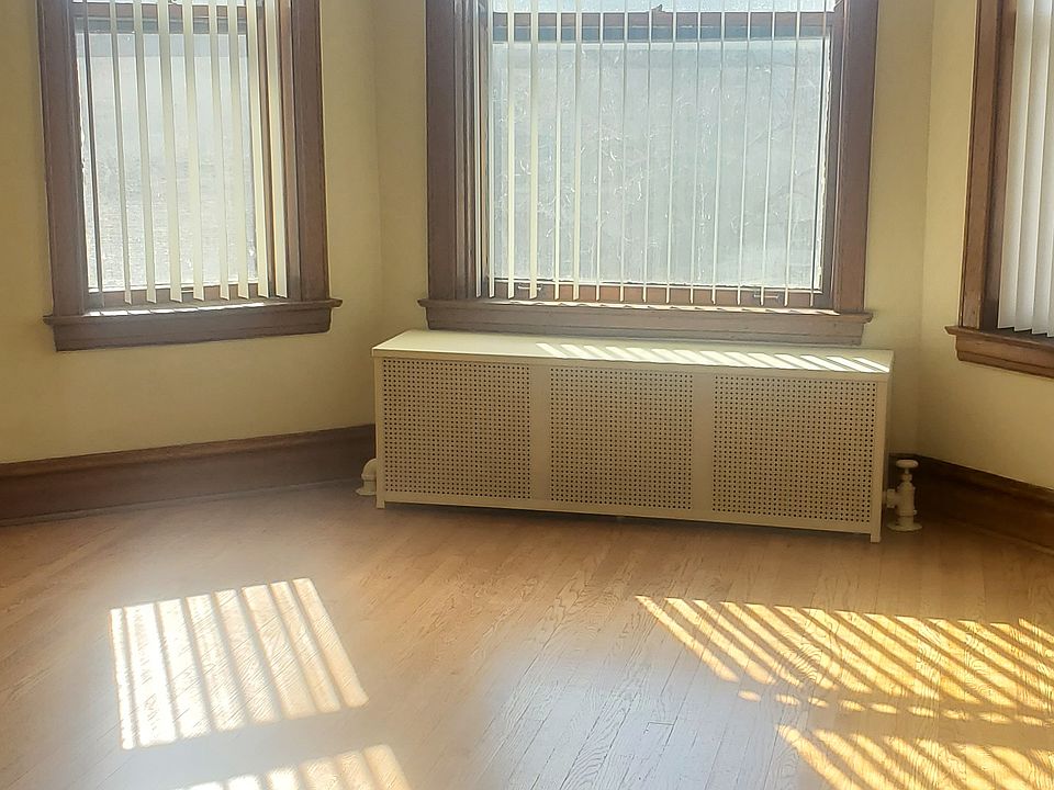Living-room: Lots of light! Covered radiator, high ceilings, new vertical blinds. Office/possible bdrm, at right (not seen in pics).
