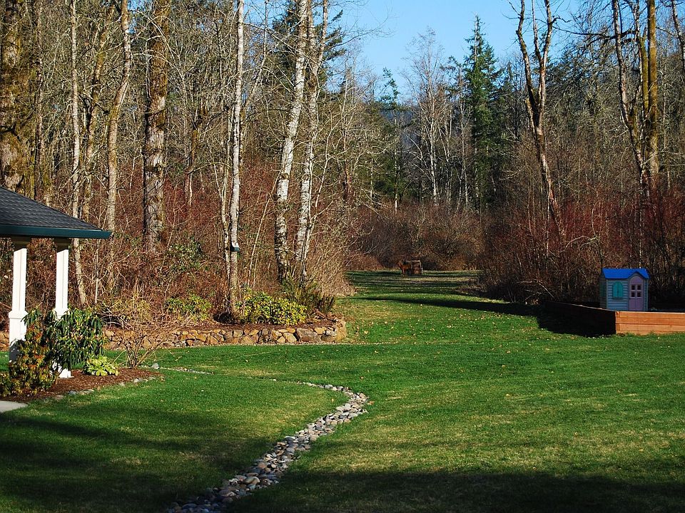 Secluded meadow tucked behind trees.