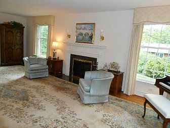 Marble Surround Fire Place Flanked By Tall Windows