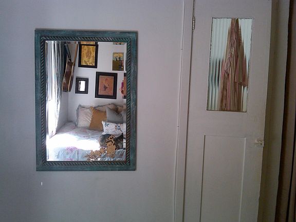 The charming old door leads into the bathroom.